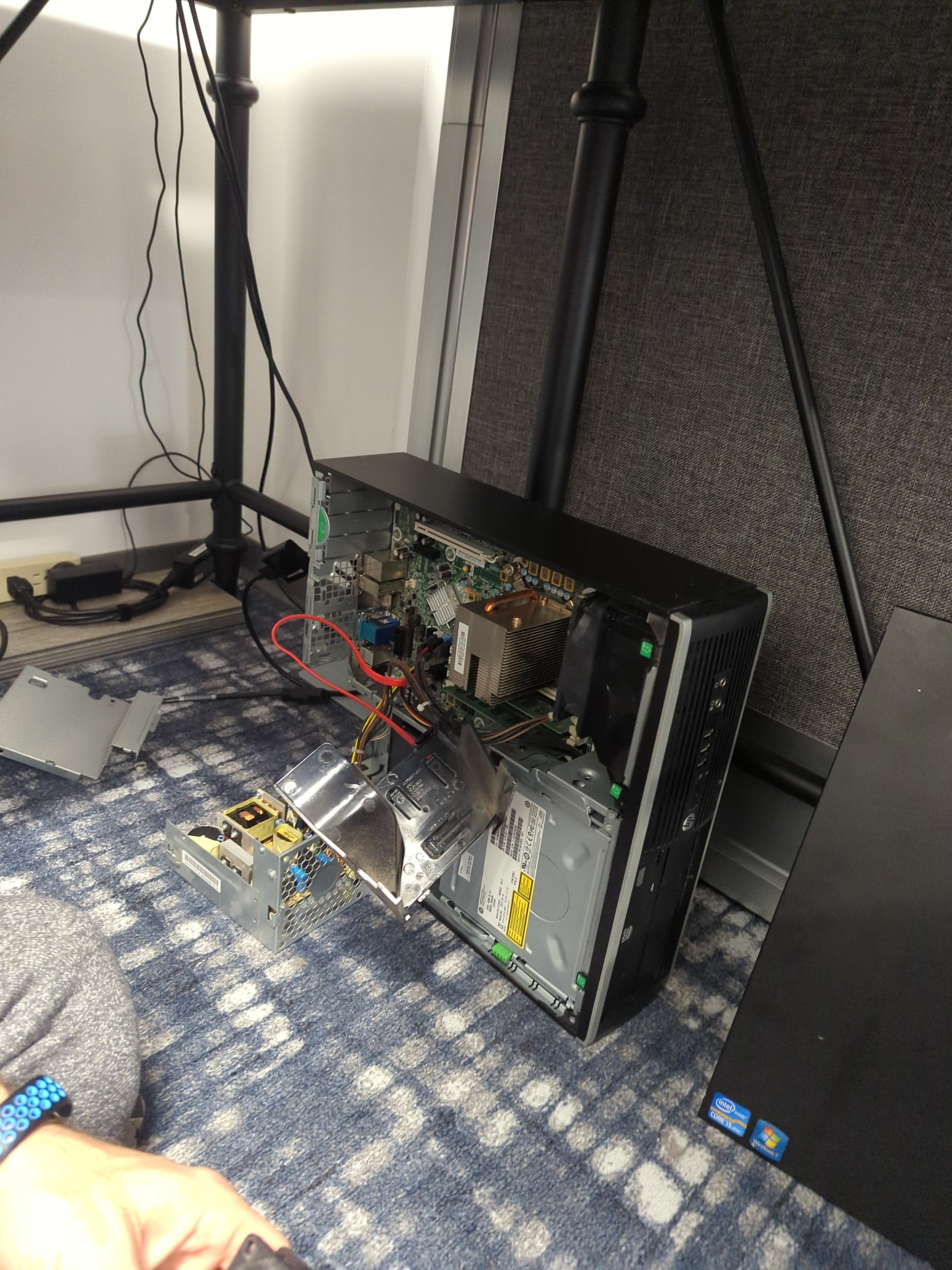 Desktop computer opened for on-site repair under a desk